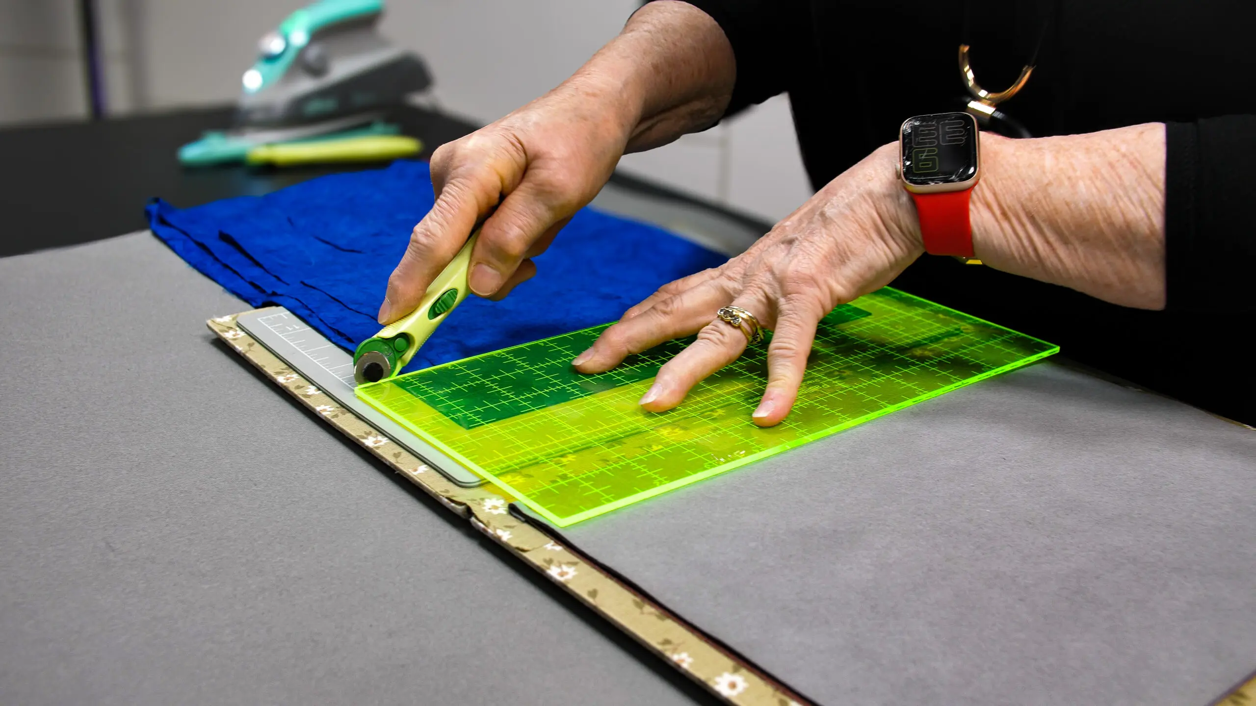 A small yellow 18mm rotary cutter placed next to a larger 45mm rotary cutter for size comparison.